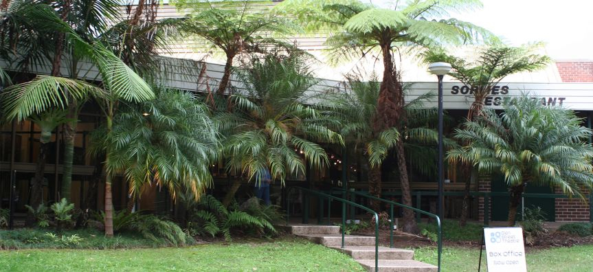 palm trees outside of the glen street theatre building
