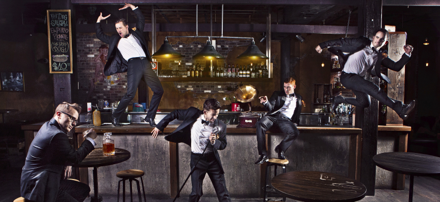 The Tap Pack, Five men wearing tuxedos in various dance poses at a bar