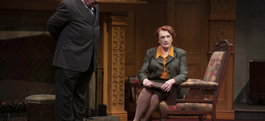 Gerry Connolly & Geraldine Turner in the 2022 Australian production of THE MOUSETRAP. Gerry stands by the fireplace looking down on  Geraldine sitting on a lounge chair