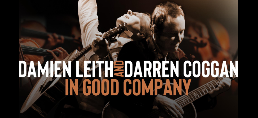 Image of performers Damien Leith and Darren Coggan playing guitars. They look happy.