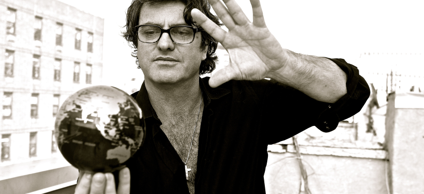 Founder of Manhattan Short, Nick Mason  holds a small silver globe in his hands. The photo is in black and white