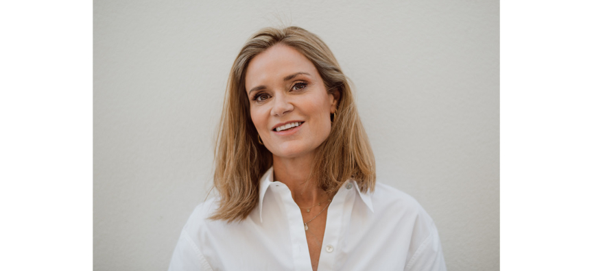 Close up image of Julia Baird wearing a white button up shirt.
