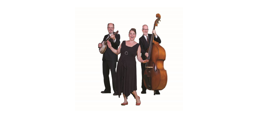 A picture of three performers - two men playing string instruments and a joyful lady in the front. 