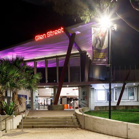 An image of Glen Street Theatre at night with the interior brightly lit